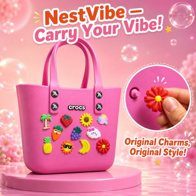 NestVibe silicone jelly crocs tote bag in magenta pink with original daisy, grape, carrot, and cloud charms on a glossy display pedestal