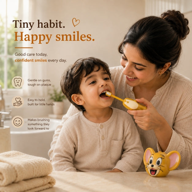 Mother gently brushing her child’s teeth with the NestPop Jerry kids toothbrush in a warm bathroom setting