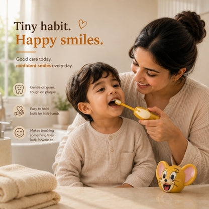Mother gently brushing her child’s teeth with the NestPop Jerry kids toothbrush in a warm bathroom setting