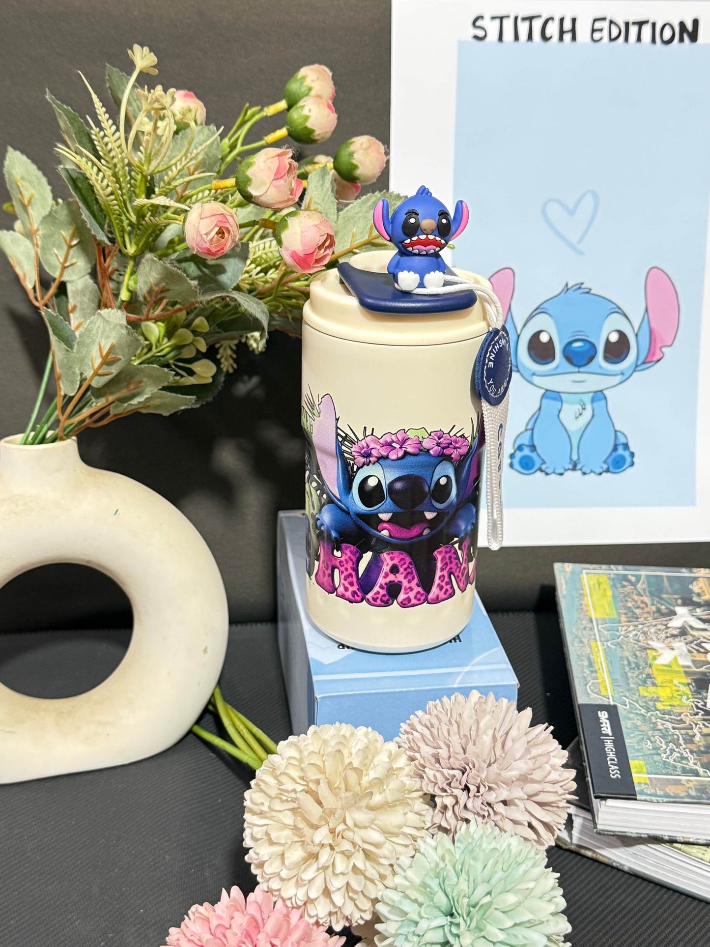Nestush 450ml insulated kids tumbler featuring a blue character with pink tropical flowers, character topper and carry strap