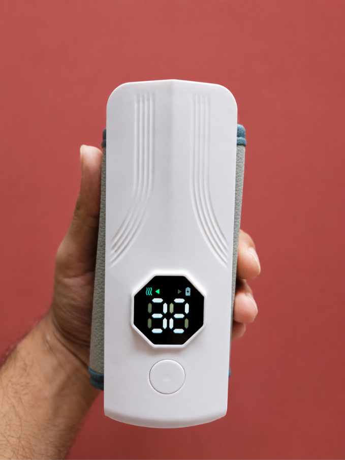 Nestush rechargeable bottle warmer held in hand showing compact size
