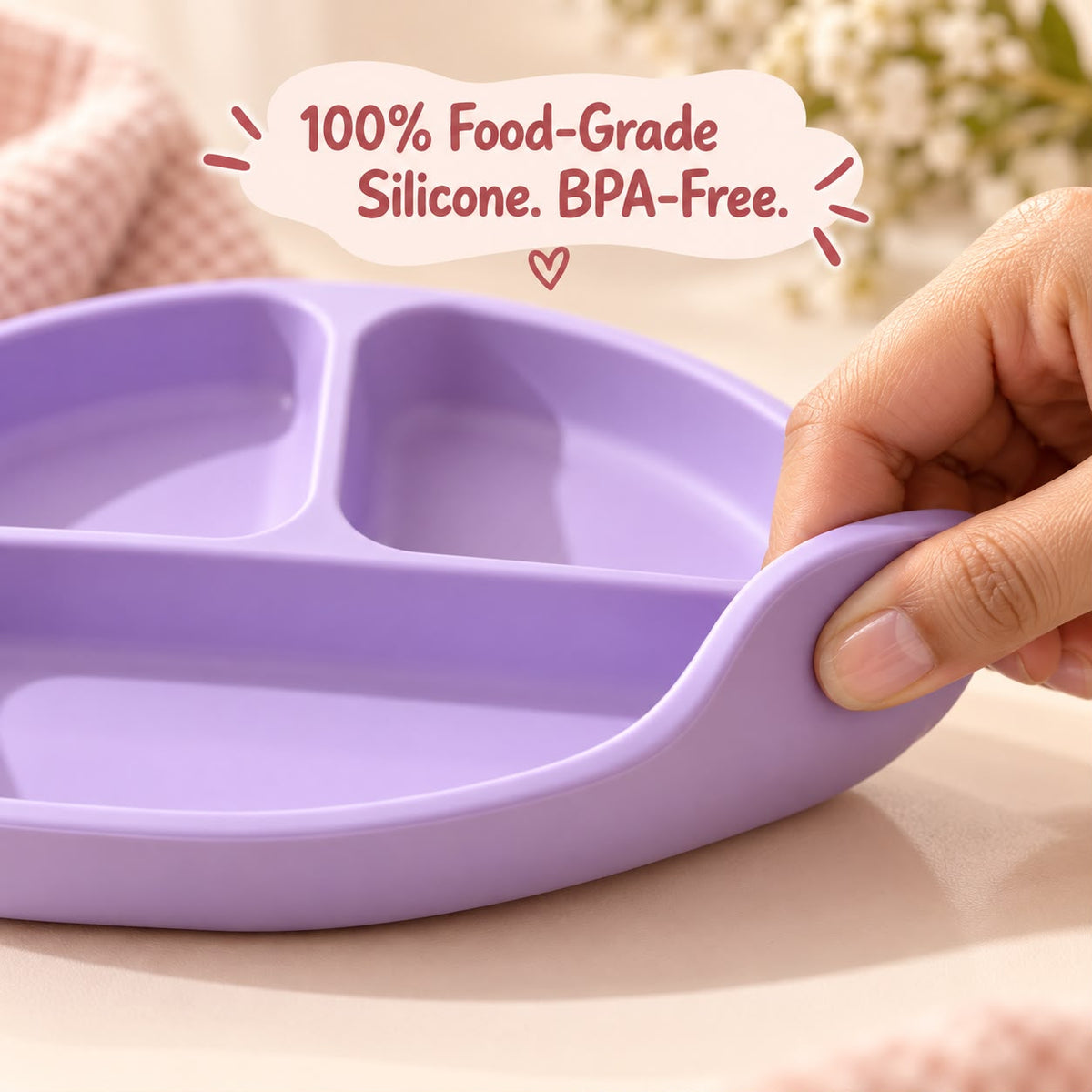 Baby eating from lavender silicone suction plate at mealtime